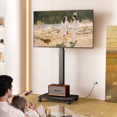 a man and woman watching television in their living room