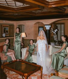 the bride and her bridesmaids are posing for a photo in their living room