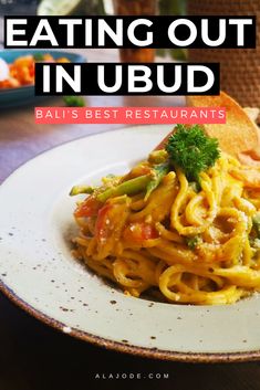 a white plate topped with pasta and broccoli