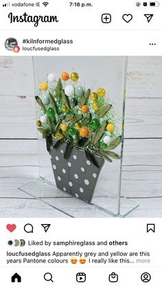 a vase filled with lots of green and yellow flowers