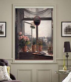 a room with pictures on the wall and flowers in vases next to a chair