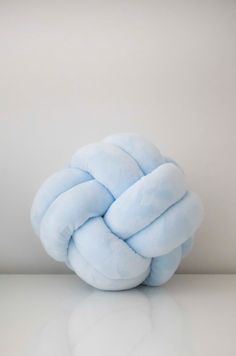 a blue knot sitting on top of a white table