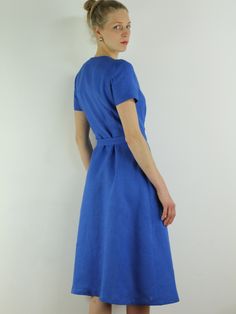 "Spring dress, Write the selected color in the message Handmade blue bayou wrap dress with short sleeves, 2 pockets and belt , perfect for casual wear and suitable for any occasion in any season Details: - 100% natural linen produced in Europe ; - medium weight (180 gram per square meter); - color: blue bayou , could be any from our colors catalog (color samples at the photo); Made to order, approximately a few days, If you have any questions please message me and I will be glad to answer. Size Blue Belted Short Sleeve Dress, Blue Short Sleeve Belted Midi Dress, Blue Belted Midi Dress With Short Sleeves, Fitted Short Sleeve Linen Dress For Work, Fitted Linen Dress With Short Sleeves For Work, Summer Midi Dress With Short Sleeves And Tie Waist, Short Sleeve Linen Dress For Beach, Short Sleeve Linen Dress For Summer Workwear, Elegant Short Sleeve Linen Dress With Belt