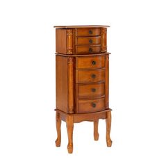 an antique wooden jewelry cabinet with drawers