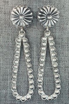 These sterling silver earrings were made by Navajo silversmith Eugene Charley. The backs are signed Eugene Charley and stamped sterling.Length: 4 1/8"Width: 1"Free shipping on all orders! We ship with USPS and always include tracking. All orders ship within a day of payment.Returns are accepted up to 30 days after you receive your order. Just send us a message. Our shop offers cash back or store credit. The item must be returned in new condition. Southwestern Silver Concho Earrings, Elegant Silver Concho Earrings, Silver Teardrop Concho Earrings, Silver Concho Drop Earrings, Southwestern Silver Earrings With Oxidized Finish, Traditional Silver Concho Jewelry, Sterling Silver Concho Dangle Jewelry, Silver Concho Dangle Earrings, Silver Dangle Earrings With Concho