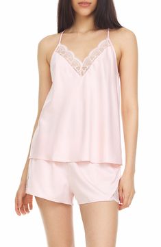 Perfect for romantic evenings, this elegant pajama set crafted in smooth matte satin includes a lace-trimmed racerback camisole and matching shorts. 2-piece set Top has V-neck; adjustable straps; open racerback; scalloped lace trim; satin construction Shorts have elastic waist; scalloped lace trim; satin construction 100% polyester Hand wash, dry flat Imported Model stats: 5'10" height, 32" bust, 25" waist, 36" hip. Model is wearing size S. Elegant Camisole Sleepwear For Loungewear, Feminine Sleeveless Sleep Sets, Feminine V-neck Camisole For Pajama Party, Feminine Cami Sleepwear For Night, Elegant Cami Sleepwear For Loungewear, Elegant Sleep Sets With Camisole, Elegant Camisole Sleep Sets, Spring Sleeveless Night Sets, Elegant Sleeveless Sleep Sets