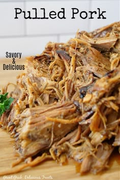 shredded meat sitting on top of a wooden cutting board