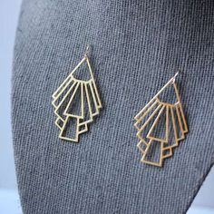 These gold tone Art Deco earrings are quintessentially modernist: geometric straight lines with the architectural spirit of the age.

 	Lightweight laser-cut pendants are statement-sized at 2" long by 1 1/2" wide.
 	Also available in silver tone on 925 sterling silver earring wires.
 	These earrings only available in French loops.

Dress these up or down. Expect compliments.

Shop more Art Deco at minusOne.

Learn more about Modernist Art Deco jewelry and the spirit of the Art Deco era on the mi 1920s Architecture, Art Deco Wedding Jewelry, Art Deco Inspired Jewelry, Architecture Light, Tone Art, Art Deco Jewelry Vintage, Modernist Art, 925 Earrings, Deco Architecture