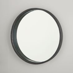 a round mirror hanging on the wall