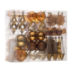 an assortment of christmas ornaments in a clear display case on a white background with clippings