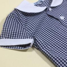 Retro styled classic gingham boys shirt. Gingham shirt with white button detail. Red, yellow, blue, black gingham. White cotton. White collar and buttons. Hand sewn finish. 6-12m Chest...29cm Nape to hem...33cm 12-18m Chest...31cm Nape to hem...35cm 18-24m Chest...32cm Nape to hem...37cm 2-3y... Chest...33cm Nape to hem...39cm 3-4y Chest...35cm Nape to hem...41cm Gift wrapped. From a smoke free and pet free home. Preppy Gingham Collared Tops, Gingham Shirt With Buttons For Summer, Summer Gingham Shirt With Buttons, Cotton Gingham Top With Button Closure, Preppy Gingham Shirt For Summer, Summer Preppy Gingham Shirt, Preppy Summer Shirt With Buttons, Classic Gingham Cotton Top, Plaid Collared Shirt For School