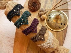 a wooden table topped with lots of different bracelets