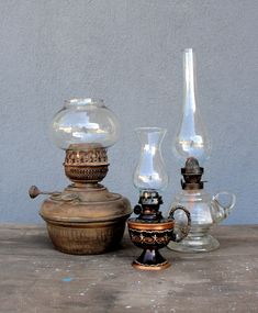 three glass vases sitting next to each other on a table