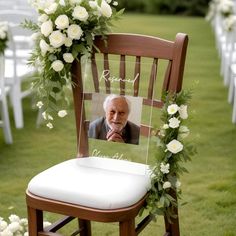 an old man is sitting in a chair with flowers on the seat and his face