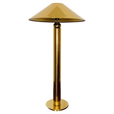 a gold colored table lamp on a white background