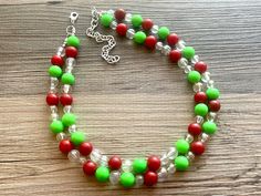 Great necklace for the holiday season! Various shades of red, green, and aurora borealis acrylic beads in our signature confetti style :) Approximately 16 inches long plus a 4 inch extender chain. *Smoke and pet free home!* I ship 6 days a week! Thank you for browsing my store! Christmas Beaded Necklaces, Green Round Bead Jewelry For Holidays, Adjustable Round Beads Necklaces For Christmas, Adjustable Festive Necklaces For Christmas, Adjustable Festive Necklace For Christmas, Christmas Party Beaded Necklaces With Round Beads, Christmas Party Round Bead Necklaces, Christmas Gift Beaded Necklaces With Round Beads, Red Beaded Christmas Jewelry