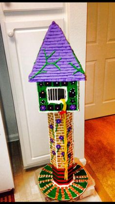 a colorful birdhouse made out of paper mache