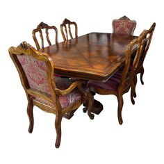 a wooden dining table with chairs around it