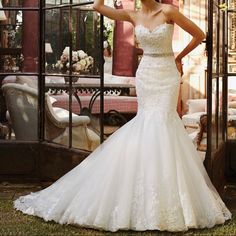 a woman in a wedding dress posing for the camera