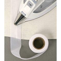 a roll of white tape next to an iron