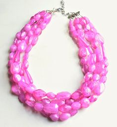 A beaded multi strand statement necklace made with light weight pink Lucite beads of various shapes. - Necklace has 4 strands (more strands available)- Shortest strand measures 19-21" long- Lobster claw clasp is surgical steel (gold filled, sterling silver or gold surgical steel clasp also available) - Connector is lead free pewterThe necklace length and number of strands can be customized. More colors are available. Please let us know what you are looking for. All DLD jewelry comes in a silver Pink Multi-strand Faceted Beads Jewelry, Pink Multi-strand Jewelry With Faceted Beads, Pink Multi-strand Necklace For Parties, Pink Multi-strand Large Beads, Pink Multi-strand Faceted Bead Necklace, Pink Multi-strand Faceted Beaded Necklace, Pink Multi-strand Jewelry With Polished Beads, Pink Multi-strand Beaded Necklace With Faceted Beads, Pink Multi-strand Beaded Necklace