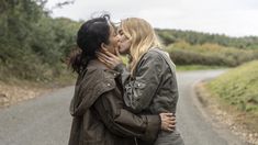 two women kissing each other on the road