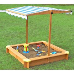 an outdoor sandbox with toys in it