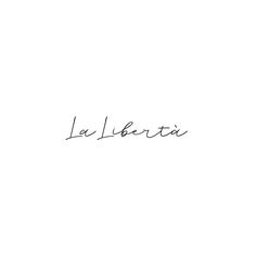 the word la liberta written in cursive ink on a white background