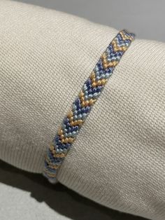 a close up of a person's arm with a woven bracelet on top of it