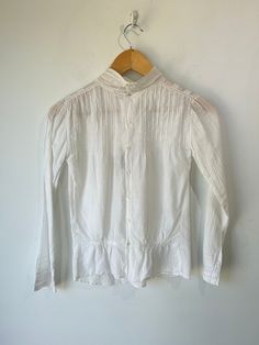 Victorian White Eyelet Shirt in really excellent condition considering it is antique. So cute! Featuring delicate lace on cuffs in a No wear visible aside from two small discoloration speckles on the collar (see photos). Unmarked size, fits many! May best fit xs/s. Wash separately in slightly warm water. Approximate Measurements: Length: 17" Underarm to underarm: 20" Casual White Blouse With Lace Cuffs, Casual Fitted Blouse With Lace Cuffs, Casual Collared Tops With Broderie Anglaise, Classic Tops With Lace Trim And Peter Pan Collar, Classic White Tops With Broderie Anglaise, Classic White Broderie Anglaise Tops, Fitted Classic Tops With Broderie Anglaise, Cotton Tops With Lace Cuffs And Long Sleeves, Classic Cotton Lace Top Blouse