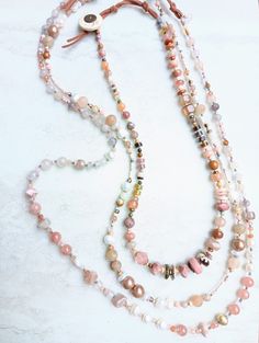 Something here for everyone..3 stunning pieces to choose from. First, this extra chunky choker necklace..shorter at 20 inches and heavy on variety, contrast, and color. A blend of rich rose tones in different shapes and textures. Mixed gemstone necklace but is primarily Rhodonite, Carnelian, Citrine, Tourmaline, Pink Turquoise, Opal, Prehnite, Morrocan Agate, Sunstone, Laughing Agate, several pearls, Jade, and much more. Mix in Morrocan Clay, Czech, seed beads, bone beads, cracked glass beads, and more. Natural suede loop and coconut button, and extendable. Secondly, this neutral Fresh Water Pearl, matte Quartz, Aventurine, Howlite, and Agate layering necklace in a soft, rosey palette. This will layer in with so many looks all year long. Over 28 inches in length and extendable. A tight, st Cake Rose, Chunky Choker Necklace, Howlite Necklace, Chunky Choker, Turquoise Rose, Multi Strand Bracelet, Fresh Water Pearls, Bone Beads, Water Pearls