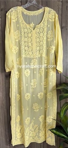 "Chikankari hand embroidered kurta on georgette.  Trendy \"ghaas patti\" embroidery on a fine fabric. Kurta length: 50 inches Liner included Pair it with a white Chikankari palazzo or  pants for a complete look!" Luxury Elegant Top With Chikankari Embroidery, Luxury Bollywood Tops With Chikankari Embroidery, Festive Chanderi Kurta With Cutwork, Yellow Georgette Kurta With Floral Embroidery, Yellow Georgette Kurta For Transitional Season, Transitional Yellow Georgette Kurta, Traditional Embroidered Cutwork Fabric For Festive Season, Traditional Festive Embroidered Cutwork Fabric, Traditional Festive Embroidered Fabric With Cutwork