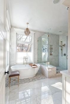 a bathroom with a tub, sink and window