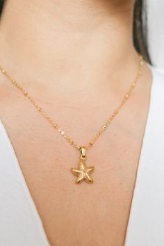 Introducing our Patricia Starfish Necklace, a charming piece inspired by coastal beauty. This necklace showcases a delicate starfish pendant, adding a subtle touch of seaside charm to your look. Versatile and understated, it's a lovely accessory for everyday wear, bringing a hint of coastal style to any outfit. All of our jewelry comes with a free jewelry pouch and cloth to keep your pretties safe and clean. Details Color: 18K Gold PlatedMaterial: Stainless SteelSize: 16in + 5cm extender Care Gu Star Charm Necklace For Beach, Starfish Shell Necklace As A Gift, Star Charm Necklaces For Beach, Beach Star Charm Necklace, Ocean-inspired Necklaces With Star Charm, Beach Starfish Charm Necklace, Ocean-inspired Starfish Shell Necklace As Gift, Ocean-inspired Starfish Shell Necklace, Starfish Charm Shell Necklace For Gift