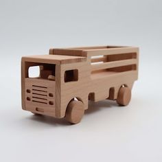 a wooden toy truck on a white background