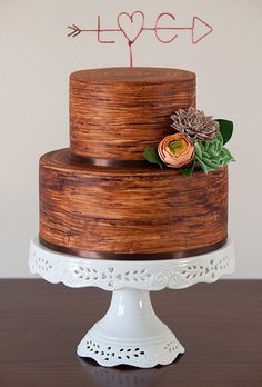 a three tiered cake with flowers on top