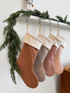 christmas stockings hanging from hooks on the wall