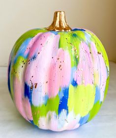 a painted pumpkin sitting on top of a table