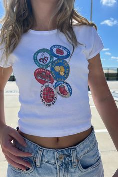 a woman wearing a white t - shirt with buttons on the front and bottom half