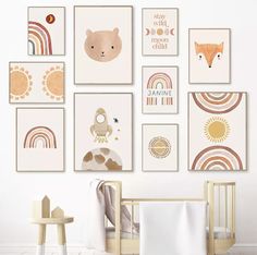 a baby's nursery room with art on the wall