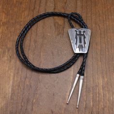 Vintage sterling silver bolo tie. The design is a Navajo spiritual figure called a yei. The bolo is 2" tall x 1 11/16" wide. The cord and tips are 44" long. MJ Sterling is stamped on the back. I have not been able to identify the hallmark. The bolo is in good condition. Thank you for shopping in our store. Please let us know if you have questions. BOLO-1568K k Southwestern Sterling Silver Bolo Tie As Gift, Southwestern Bolo Tie With Sliding Knot, Southwestern Lariat Bolo Tie For Rodeo, Artisan Silver Lariat Bolo Tie, Adjustable Sterling Silver Lariat Bolo Tie, Silver Lariat Bolo Tie With Adjustable Length, Silver Lariat Bolo Ties With Adjustable Length, Southwestern Sterling Silver Bolo Tie, Southwestern Style Sterling Silver Bolo Tie