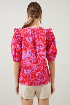 Abstract meets tropical. A fun-loving combo of a print takes on the Noche Blouse. Ruffle trim connects voluminous puff sleeves to a relaxed fit, trapeze bodice. A split neckline with a flattering tie detail sits at the center neckline. Easily style the blouse tucked into your favorite trousers or wear it untucked over your favorite breezy shorts.- Lightweight- Trapeze frame- Tie neck - Elastic cuffs- Color: Pink RedSize + Fit - Model is 5'9" and wearing size XS- Measurements taken from size S - Lit Outfits, Tulip Print, Pink Hydrangea, Polka Dot Blouse, Red Blouses