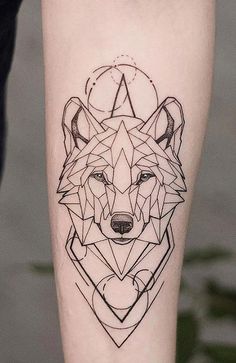 a black and white photo of a wolf tattoo on the leg with geometric shapes around it