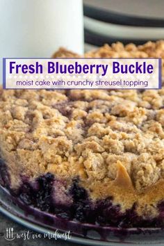 fresh blueberry buckle cake with crunchy crust and topping on a glass plate