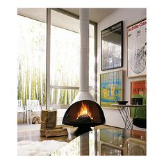 an image of a fireplace in the middle of a room with windows and pictures on the wall