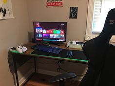 a computer desk with a keyboard, mouse and monitor