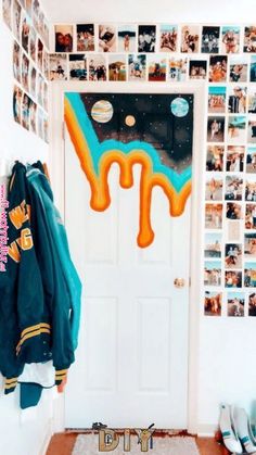 a room with pictures on the wall and a coat hanging up in front of it