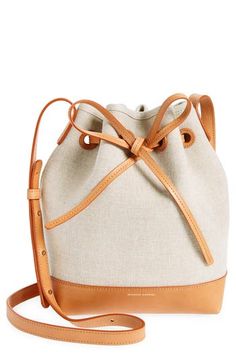 Cool Italian canvas and luxe leather shape a petite bucket bag with sturdy structure and a drawstring-cinched top. Drawstring closure Adjustable crossbody strap Structured silhouette with flat base for stability Textile with leather trim Made in Italy Designer Handbags Cinched Top, Bag Ideas, Mansur Gavriel, Leather Bucket Bag, Leather Bucket, Mini Canvas, Canvas Leather, Crossbody Strap, Leather Trim