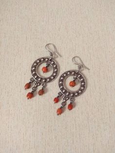 This is a beautiful vintage silver 925 earrings with old natural coral beads. These earrings are a circle with a coral bead hanging in the middle and 3 beads from the bottom These earrings have a good size and weight to be worn. Length : 8,5 cm (3,3 inches) Width : 3,5 cm (1,37 inches) Weight : 22 g Traditional Earrings With Round Natural Stones, Traditional Earrings With Natural Stones, Artisan Earrings With Dangling Beads, Gift Silver Beaded Round Earrings, Traditional Sterling Silver Earrings With Natural Stones, Silver Vintage Beaded Earrings With Dangling Beads, Silver Beaded Earrings With Natural Stones, Artisan Sterling Silver Round Bead Earrings, Artisan Sterling Silver Earrings With Dangling Beads