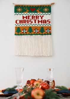 a table topped with fruit and vegetables on top of a wooden table covered in christmas decorations